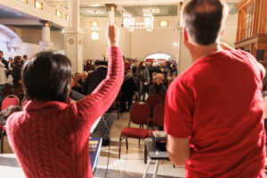 VHF Staff and volunteer stand facing crowd at event. Photo is linked to open new webpage on Community Celebration events.